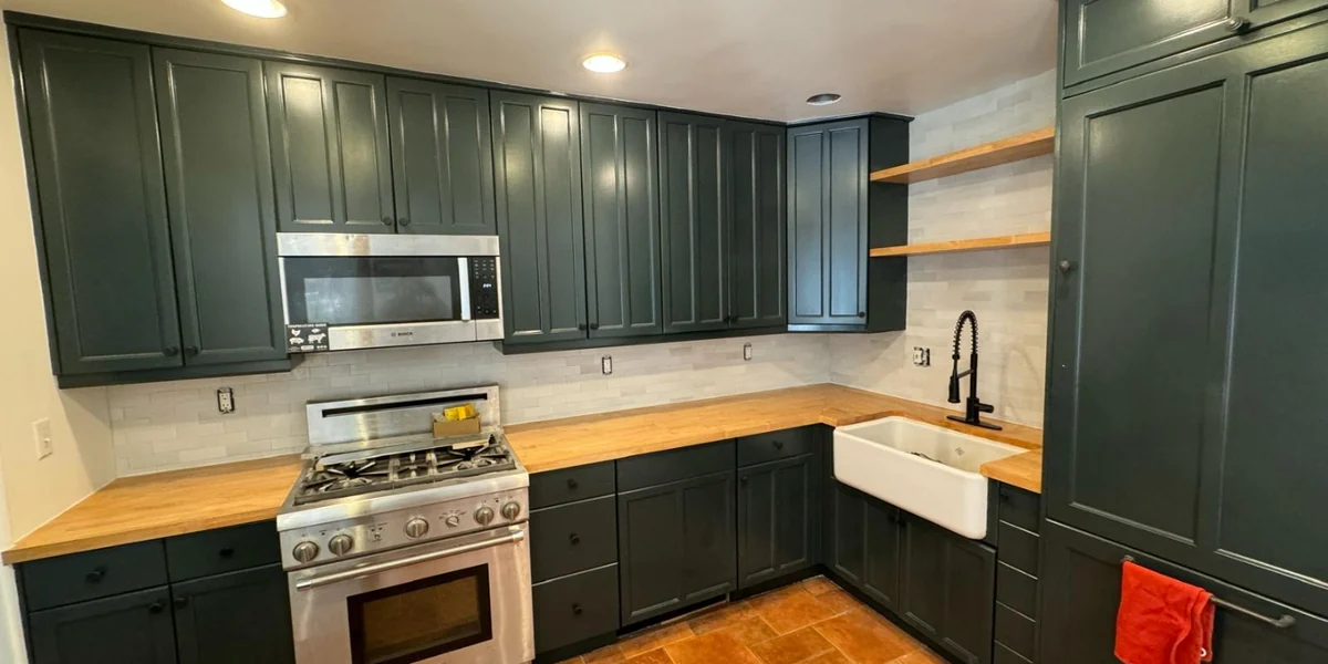 Kitchen cabinetry finished in a deep green color