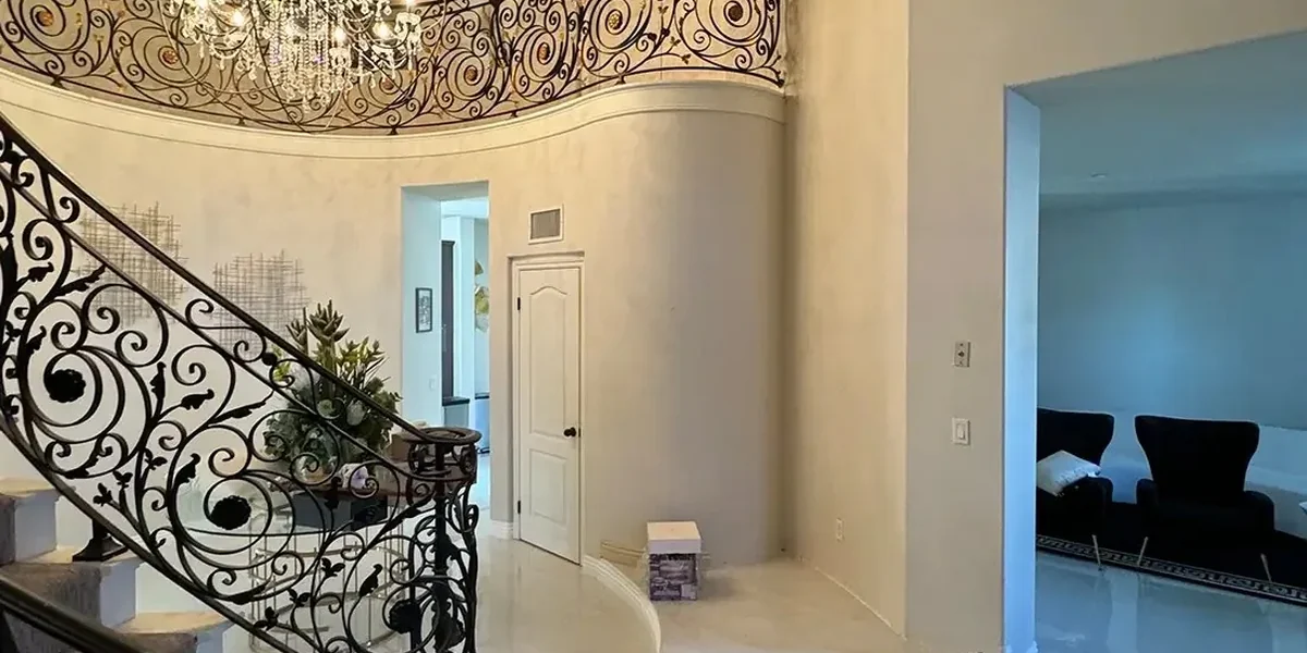Grand foyer and curved staircase after high-ceiling painting