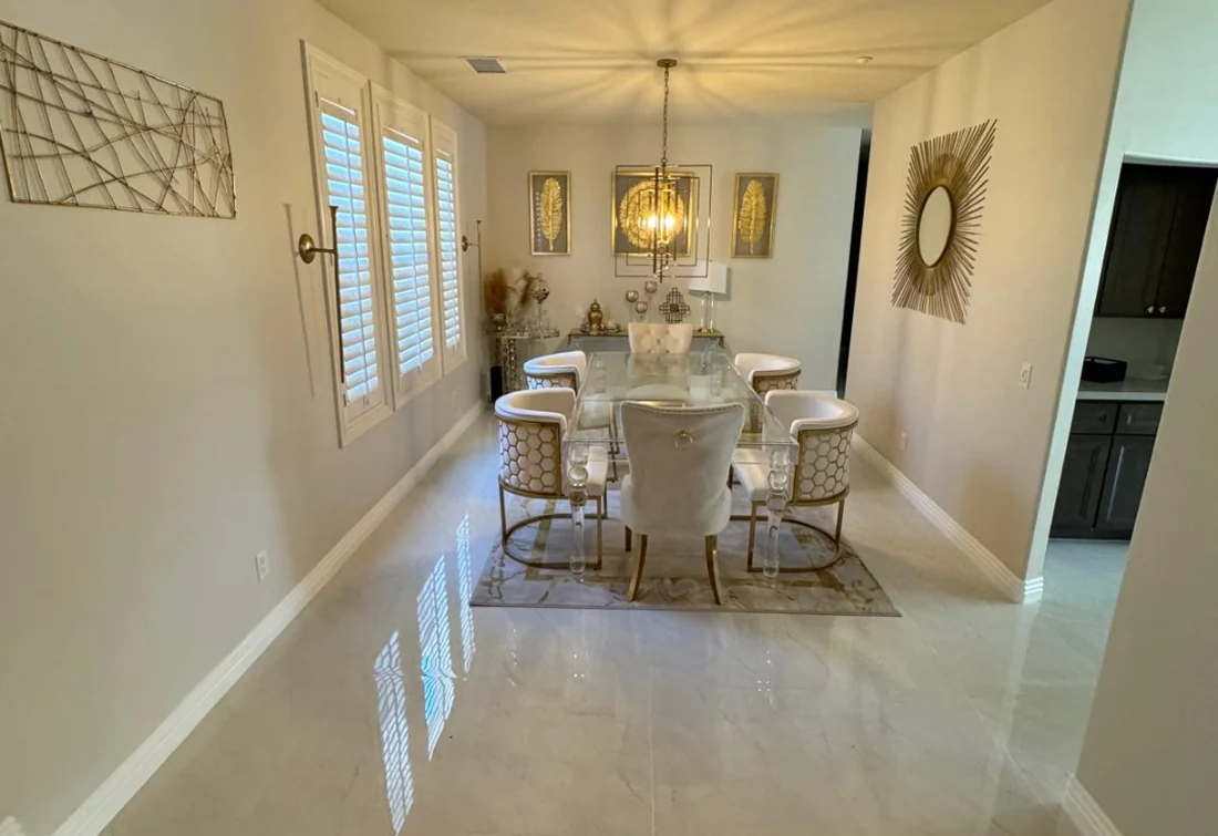 Bright dining and living area with freshly painted neutral walls